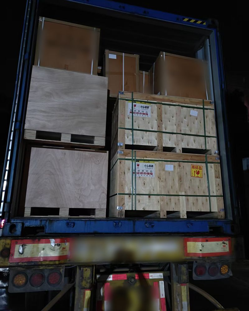 Wooden crates stowed in a 40HQ container at night